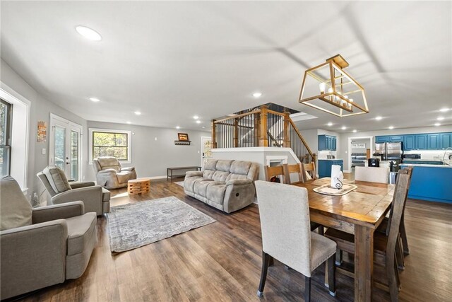 dining room featuring wood-type flooring, a notable chandelier, and french doors