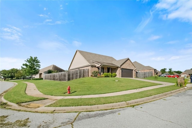 view of front of house with a garage and a front lawn