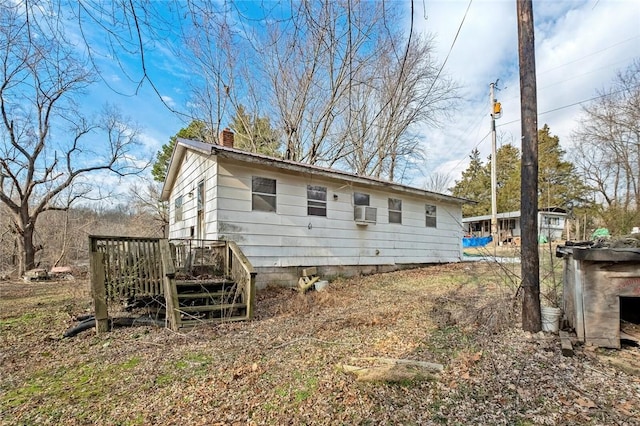 back of house with a wooden deck