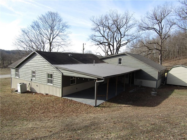 back of property featuring central AC unit