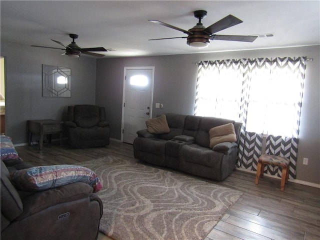 living room featuring hardwood / wood-style floors and ceiling fan