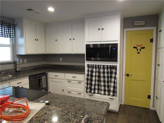 kitchen with dark stone countertops, black appliances, dark hardwood / wood-style floors, and white cabinets