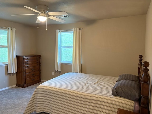 carpeted bedroom with ceiling fan, baseboards, and visible vents