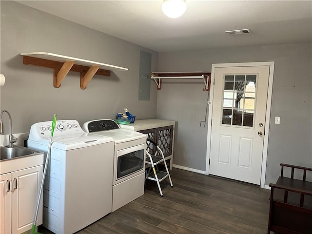 laundry room featuring dark wood finished floors, separate washer and dryer, visible vents, electric panel, and a sink