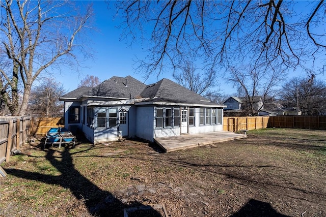 back of property featuring a patio and a yard