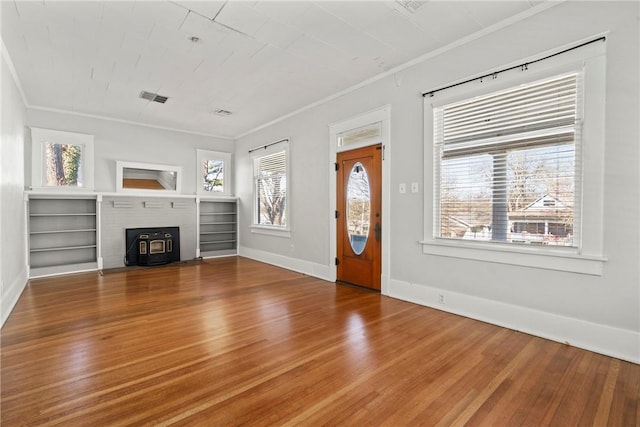 unfurnished living room with wood-type flooring and ornamental molding