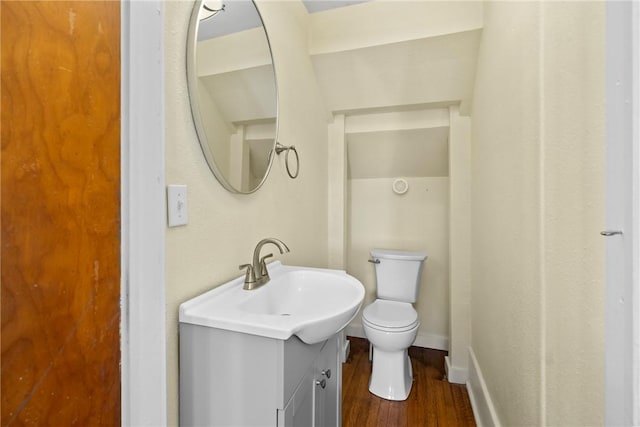bathroom with vanity, hardwood / wood-style floors, and toilet