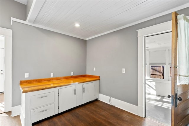interior space featuring dark wood-type flooring and white cabinets
