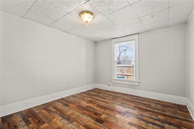 spare room with dark wood-type flooring