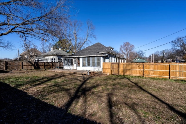 back of property with a yard