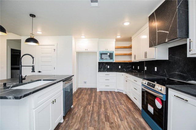 kitchen featuring white cabinetry, pendant lighting, stainless steel appliances, and wall chimney exhaust hood