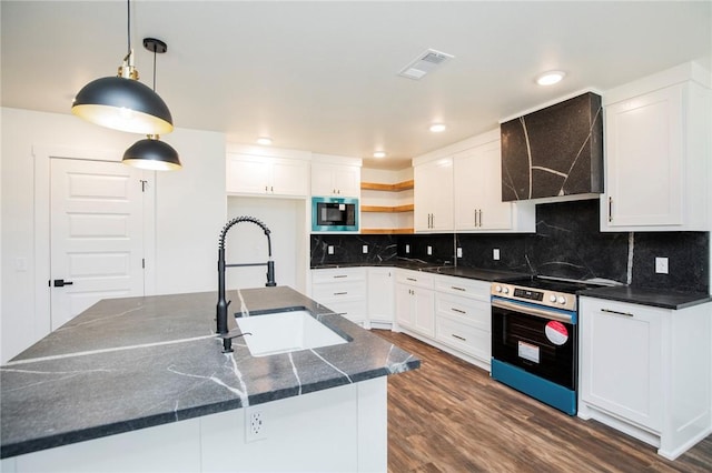 kitchen featuring stainless steel range with electric stovetop, sink, decorative light fixtures, and white cabinetry