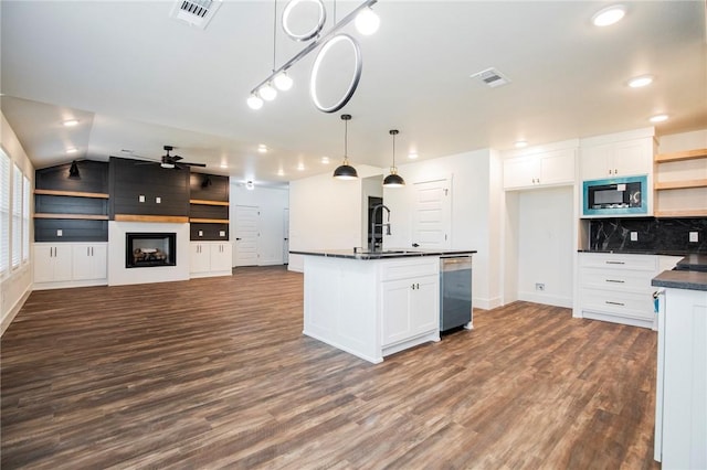 kitchen featuring white cabinetry, sink, pendant lighting, and a fireplace