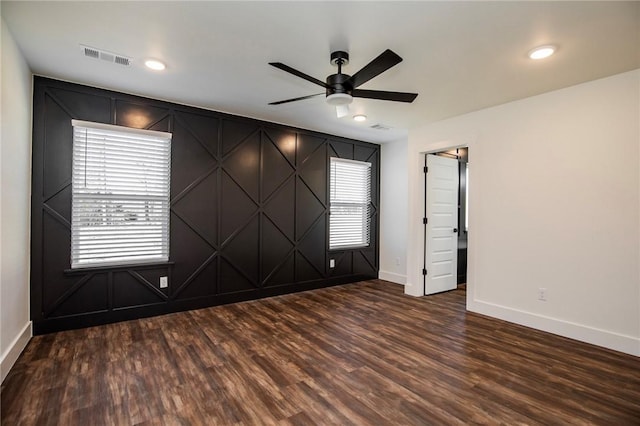 unfurnished room with ceiling fan and dark hardwood / wood-style floors