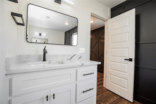 bathroom with vanity and hardwood / wood-style floors