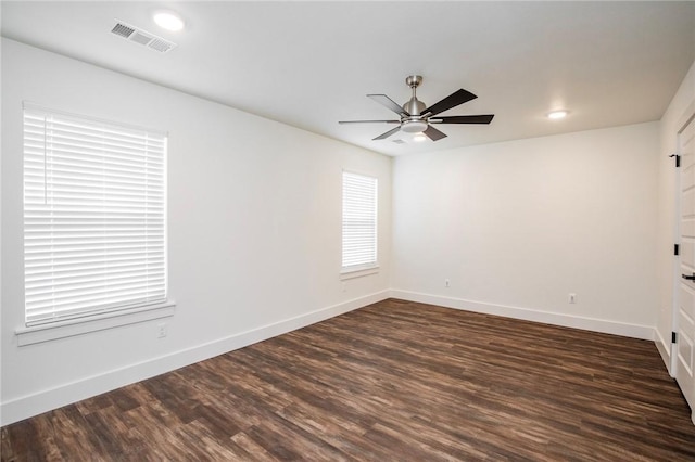 spare room featuring ceiling fan and dark hardwood / wood-style flooring