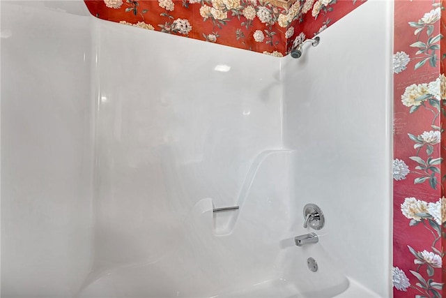 bathroom with shower / washtub combination