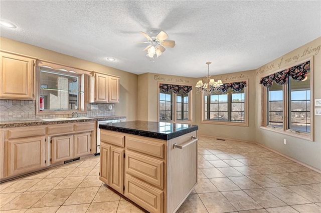 kitchen featuring tasteful backsplash, a center island, light tile patterned floors, light brown cabinets, and dishwashing machine