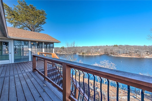 wooden terrace featuring a water view and a sunroom