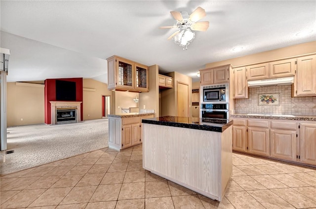 9 Marykirk Ln, Bella Vista, AR 72715 - kitchen featuring stainless steel appliances, light brown cabinetry, light colored carpet, under cabinet range hood, and vaulted ceiling