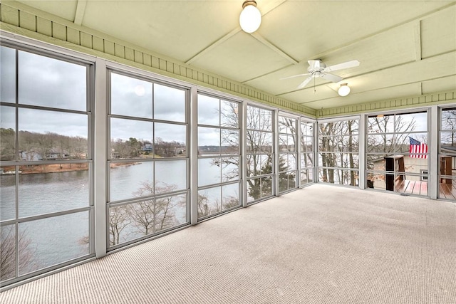 unfurnished sunroom with a water view and ceiling fan