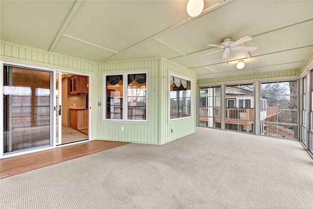 unfurnished sunroom with ceiling fan and lofted ceiling