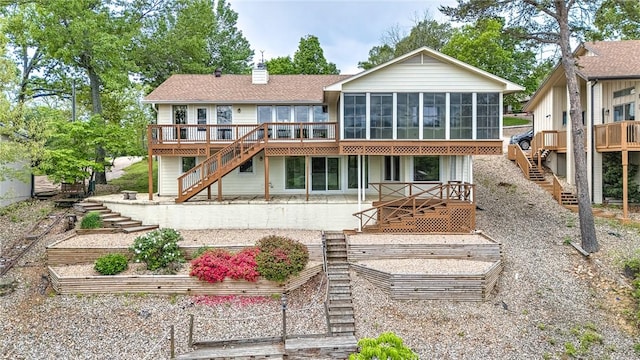 9 Marykirk Ln, Bella Vista, AR 72715 - back of house with stairs, a sunroom, a vegetable garden, a deck, and a chimney
