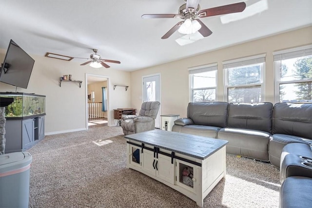 carpeted living room with a wealth of natural light and ceiling fan