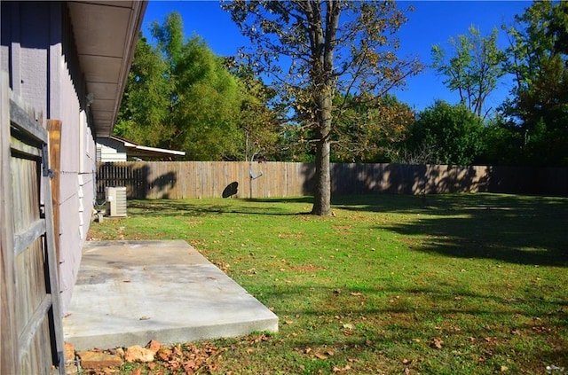 view of yard featuring central AC unit and a patio area