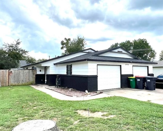 view of home's exterior featuring a yard and a garage