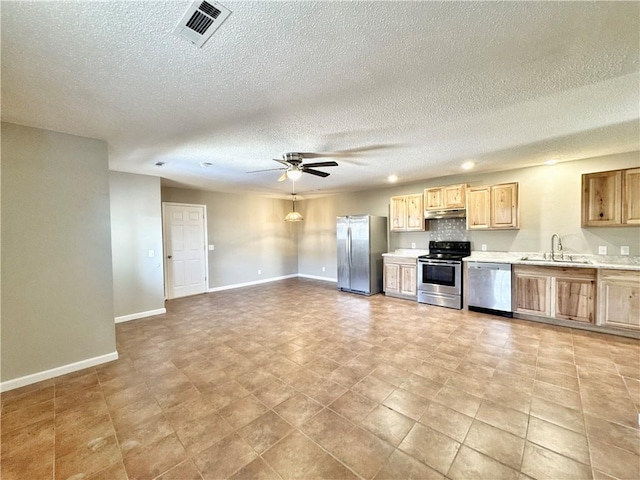 kitchen with sink, ceiling fan, stainless steel appliances, a textured ceiling, and light brown cabinets