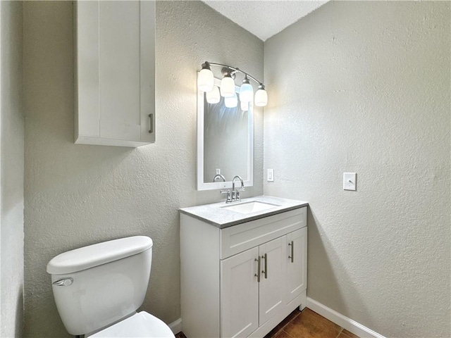 bathroom featuring tile patterned flooring, vanity, and toilet