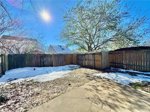 yard covered in snow with a patio area