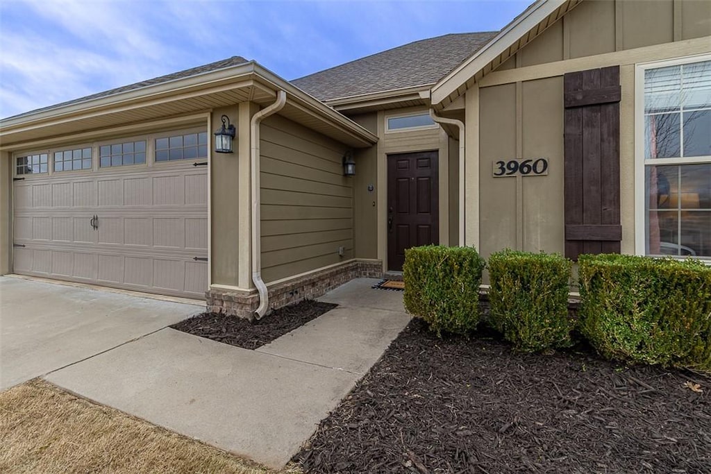 doorway to property with a garage