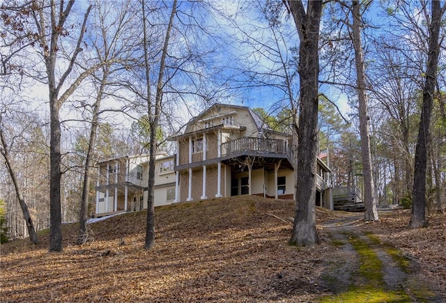 rear view of house featuring a wooden deck