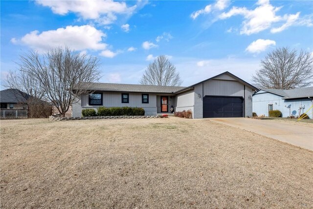 single story home with a garage and a front lawn