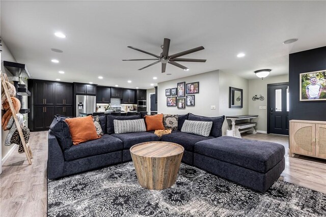 living room featuring ceiling fan and light wood-type flooring