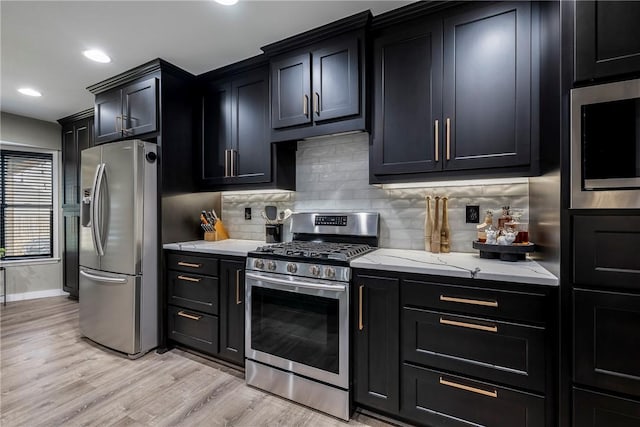 kitchen with stainless steel appliances, light stone countertops, light hardwood / wood-style floors, and decorative backsplash