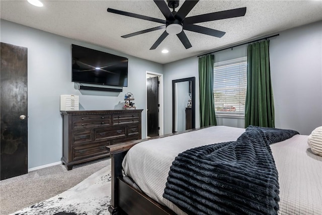 bedroom with light carpet, a textured ceiling, and ceiling fan