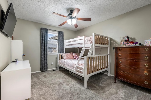 carpeted bedroom featuring a textured ceiling and ceiling fan