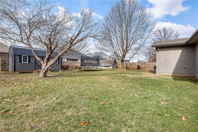 view of yard with a storage unit and a trampoline