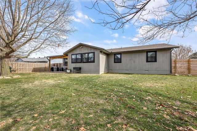 back of property featuring a lawn