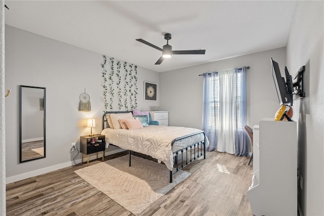 bedroom featuring hardwood / wood-style flooring and ceiling fan