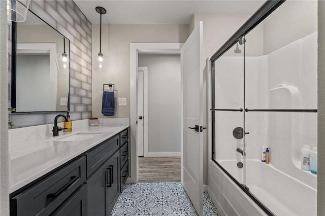 bathroom featuring tile patterned floors, vanity, and combined bath / shower with glass door