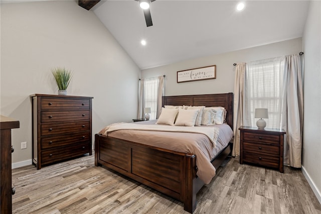 bedroom with lofted ceiling with beams, light wood-type flooring, and ceiling fan