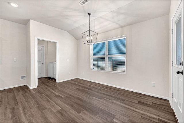 unfurnished dining area featuring lofted ceiling, washer / clothes dryer, a notable chandelier, and dark hardwood / wood-style floors