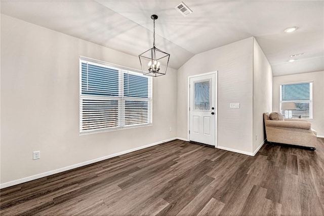 entryway with lofted ceiling, dark hardwood / wood-style floors, and a notable chandelier