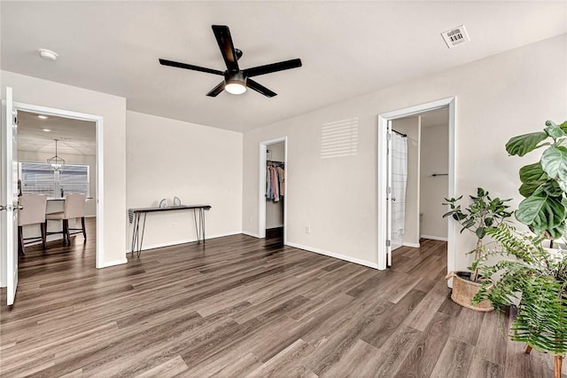 unfurnished room featuring dark wood-type flooring and ceiling fan