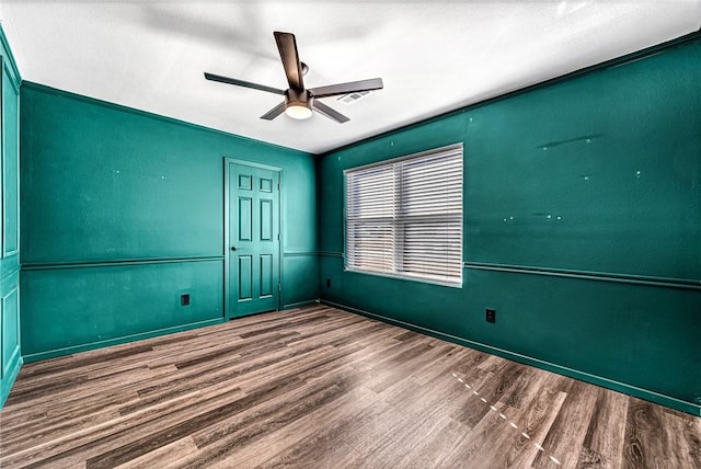 unfurnished room with hardwood / wood-style flooring and ceiling fan