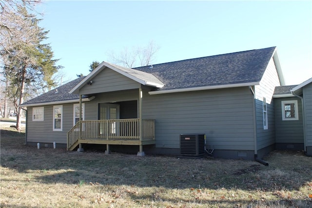 back of property featuring central AC, a deck, and a lawn